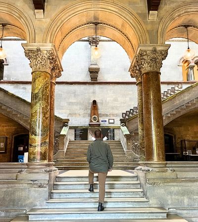 Man walking up a grand staircase